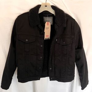 Black denim sherpa lined Levi’s jacket.